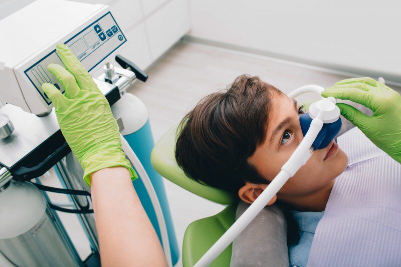 child wearing nose mask administering nitrous oxide sedation