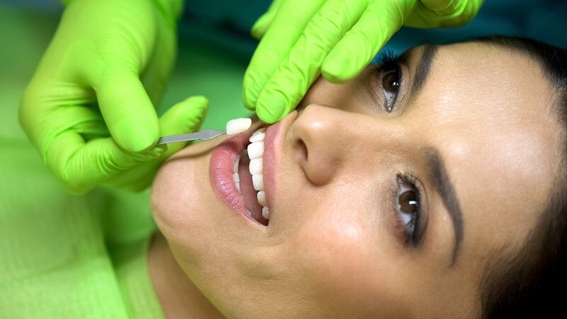 Woman having dental veneers placed