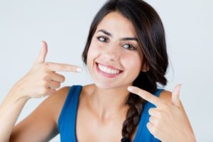 a patient in Allen pointing to her smile